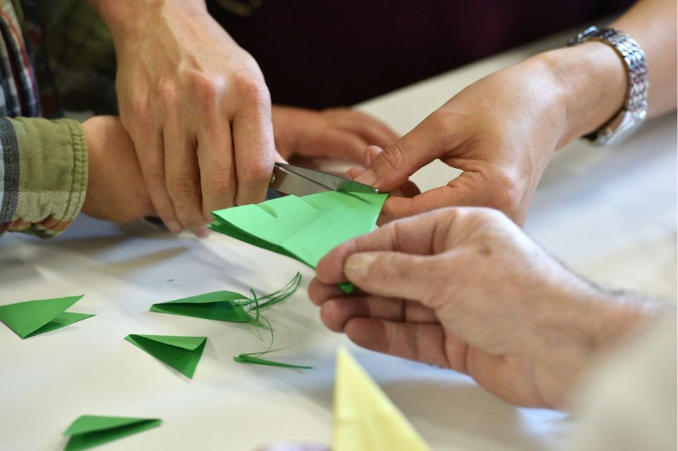A group of adults being creative with paper