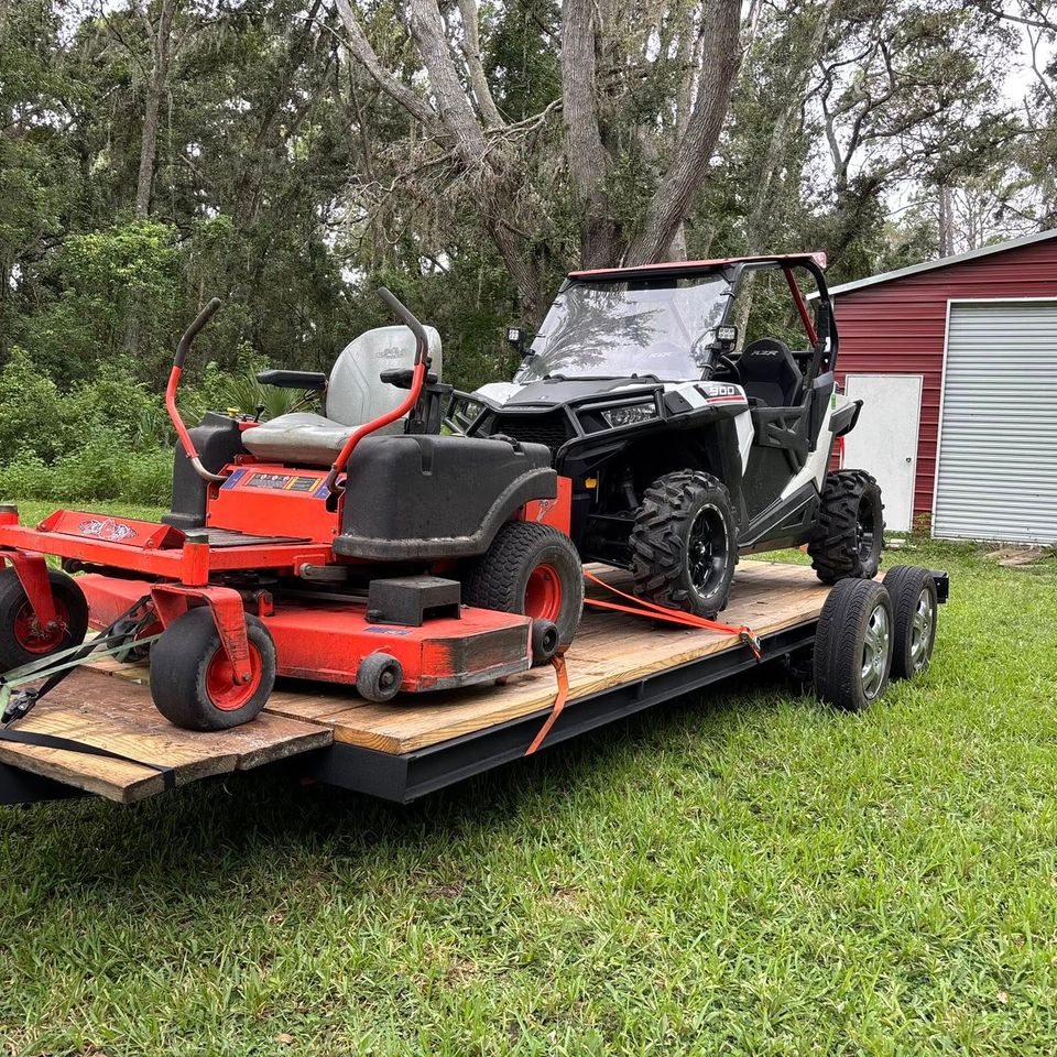 A tractor being hauled by JNJ Hauling Solutions of Citrus County