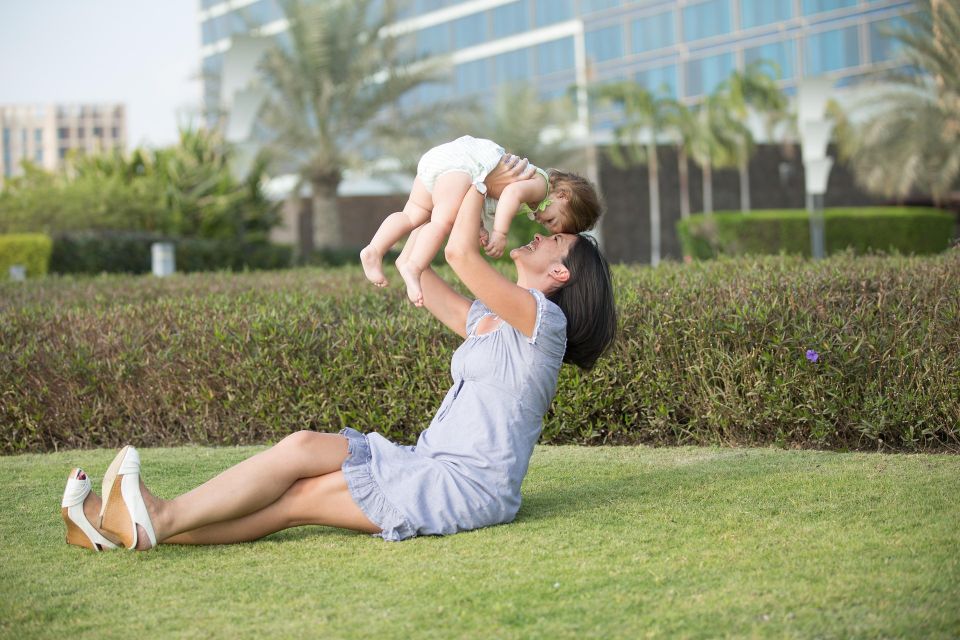 adult child and parent spending time with newborn infant in Texas