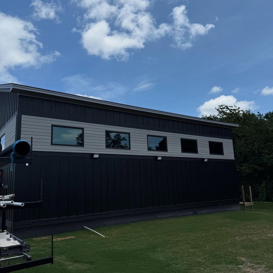 Black and gray modern building with a row of tinted clerestory windows after commercial tint in Moyock NC