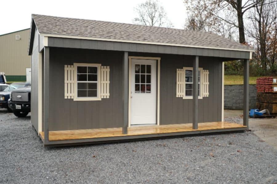 Front view of a gray country cabin with full porch and shingle roof in East Tennessee