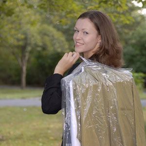 Woman carrying dry cleaning