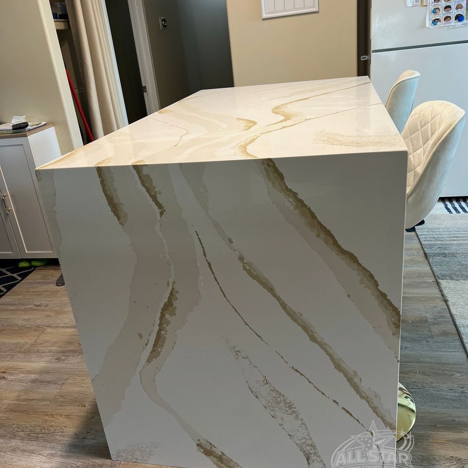 Waterfall stone countertop edge with marble-look veining in Houston, TX