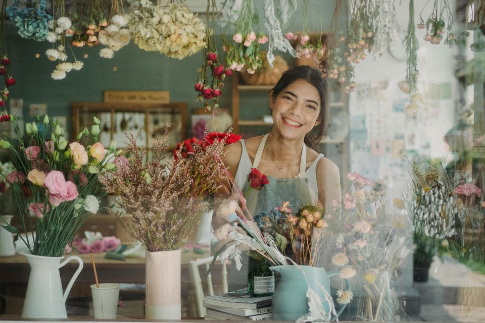 Lady smiling while working in flower shop