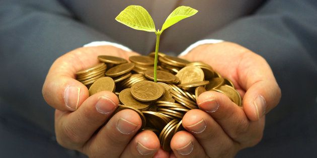 Stock photo  hands of business man holding a tree growing on golden coins business investment with csr 378765358