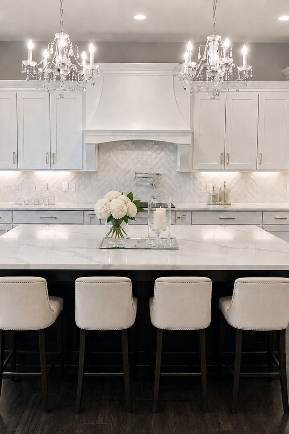 Custom white kitchen with oversized island and statement range hood in Hudson, Ohio