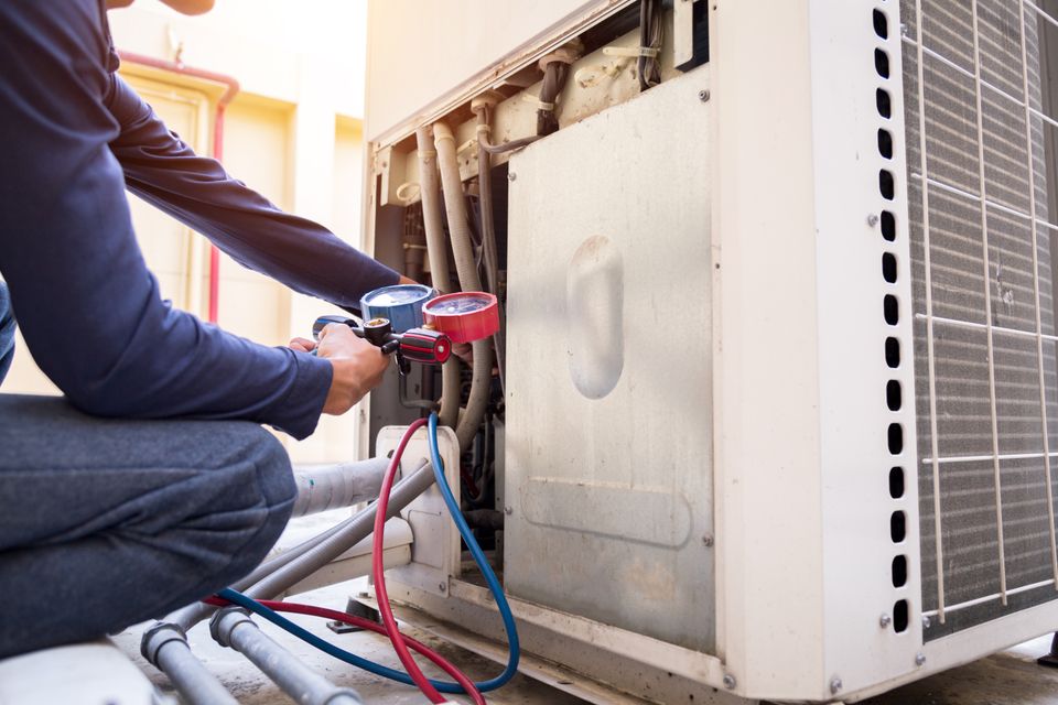 Technician is checking air conditioner measuring equipment filling air conditioners