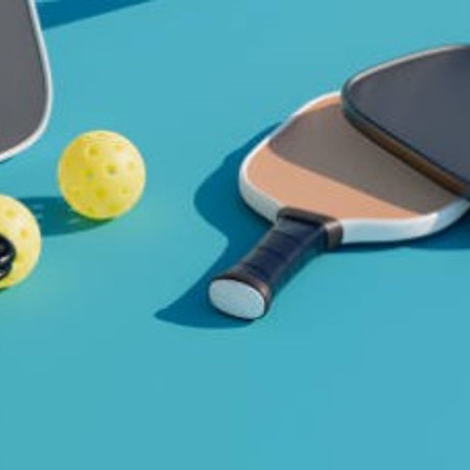 Pickleball paddles and balls used for inclusive recreation and fitness activities.