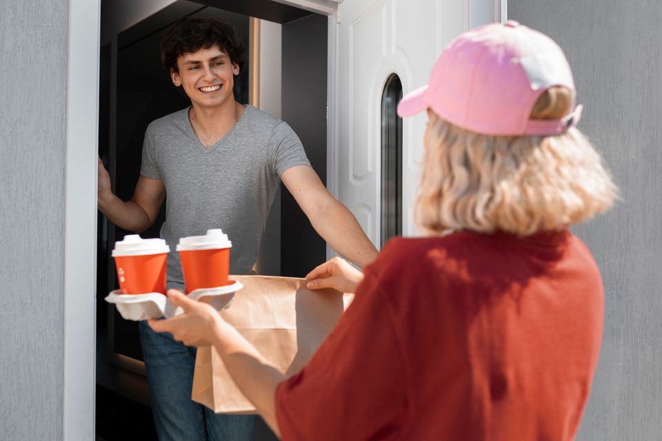 Side view woman delivering coffee
