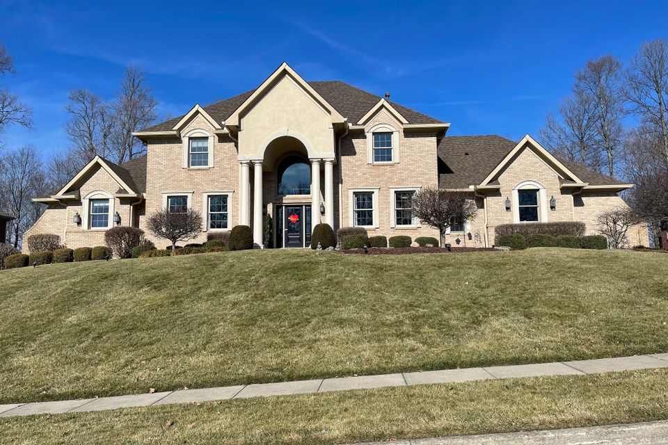 Large two-story luxury home with a professionally installed architectural shingle roof by E & D Roofing, Inc.