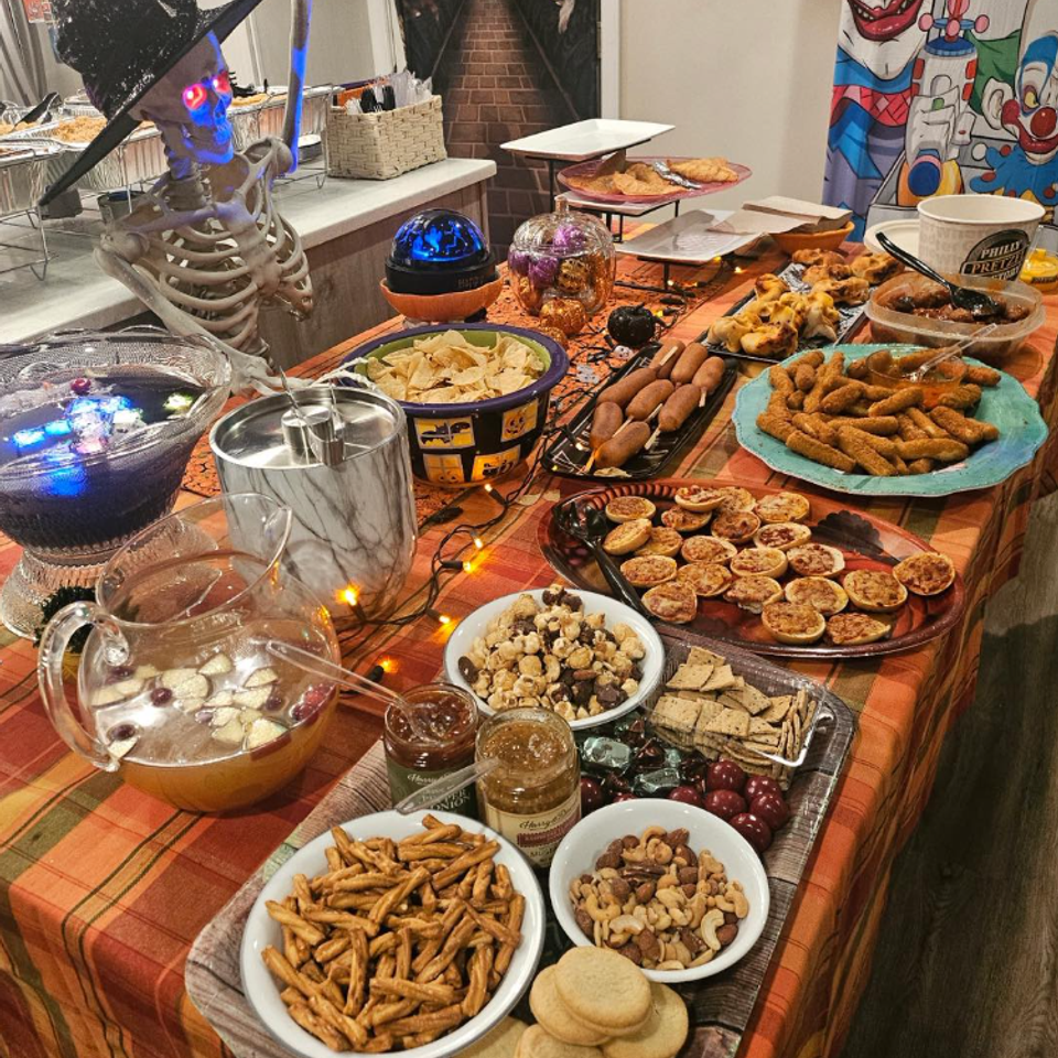 alt="The Party Savers staff bartending and waitressing at a Halloween-themed event"