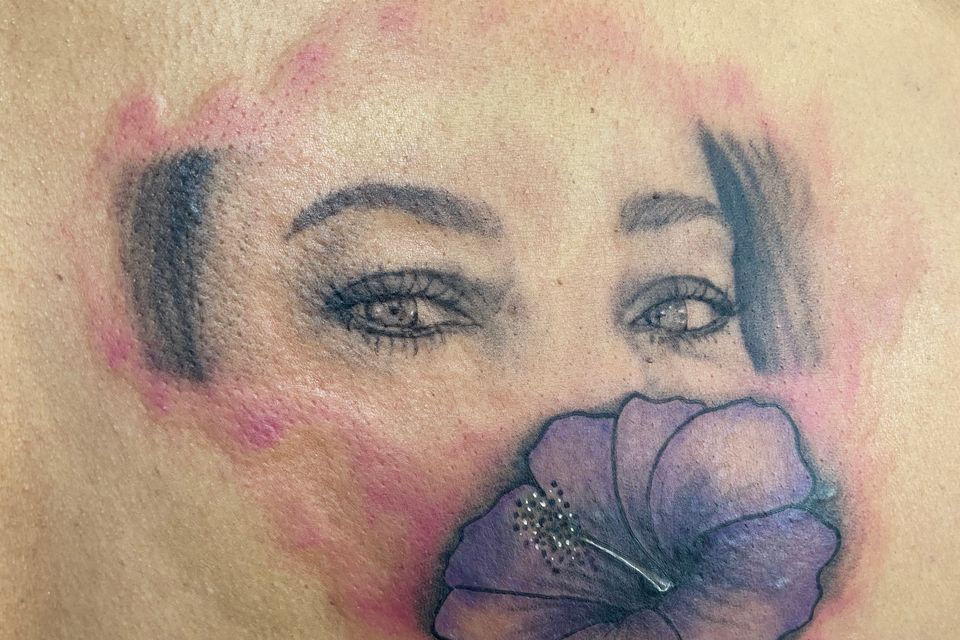 Image of one tattoo being covered over by another tattoo at the hand of tattoo artist Crazy Eagle