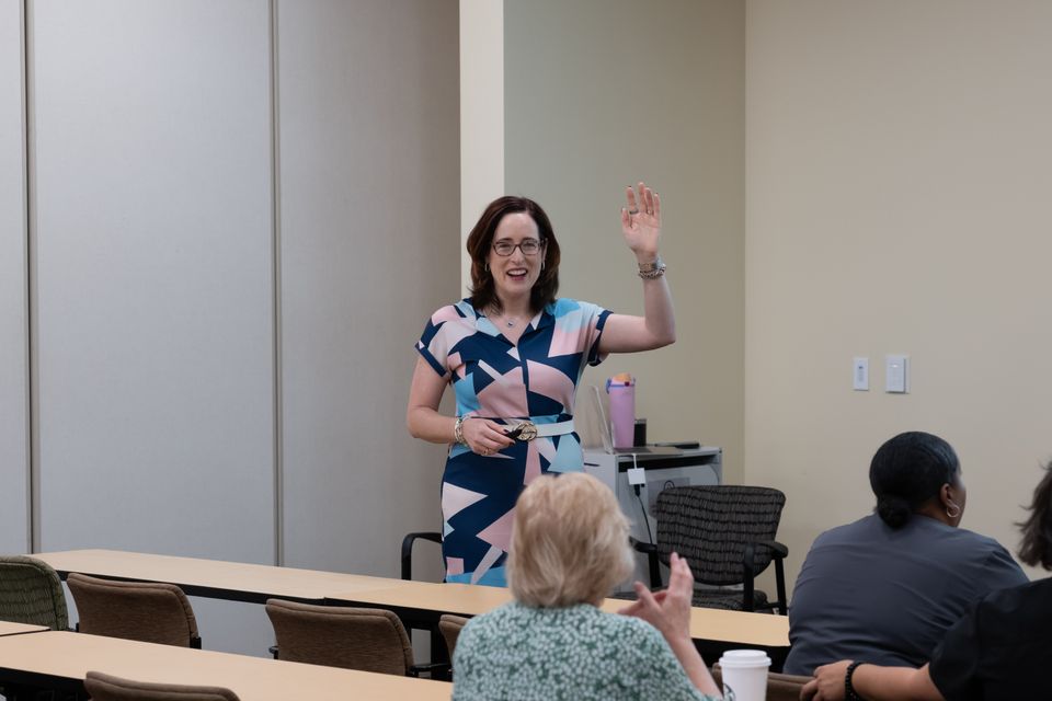 Woman standing with arm raised