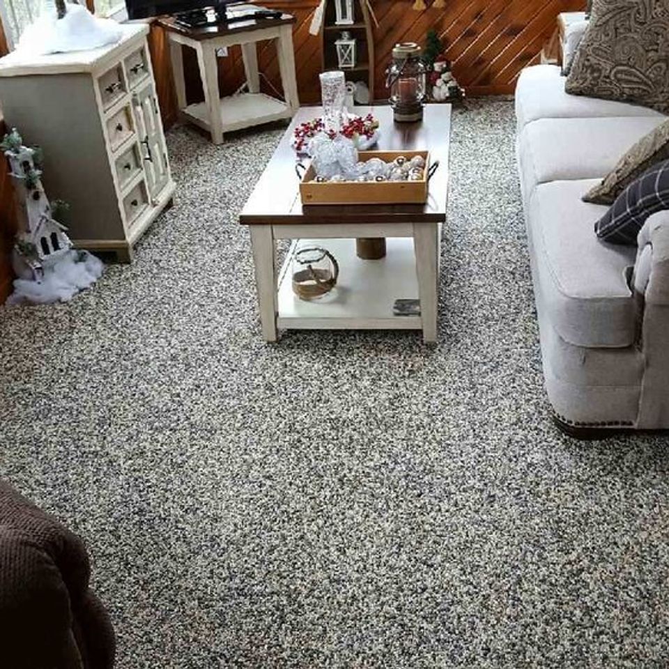 Finished basement living area featuring an EverStone decorative stone flooring system.