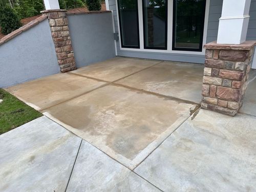 Before photo of stained patio and porch concrete in Savannah Lakes Village before resurfacing