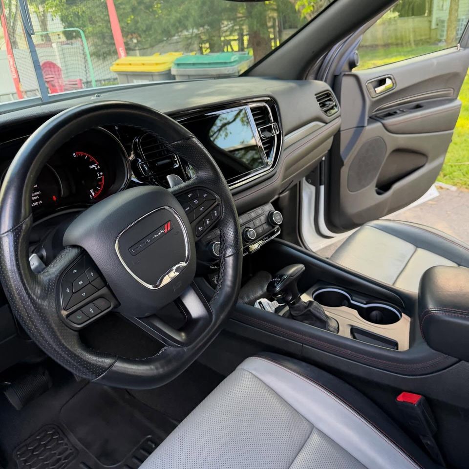 Clean Dodge Durango front cabin with gray leather seats, dash, and console after interior cleaning
