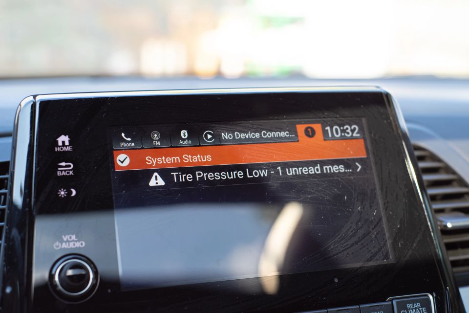 Indicator lights and message on LED display screen for tire pressure low indicator of modern car