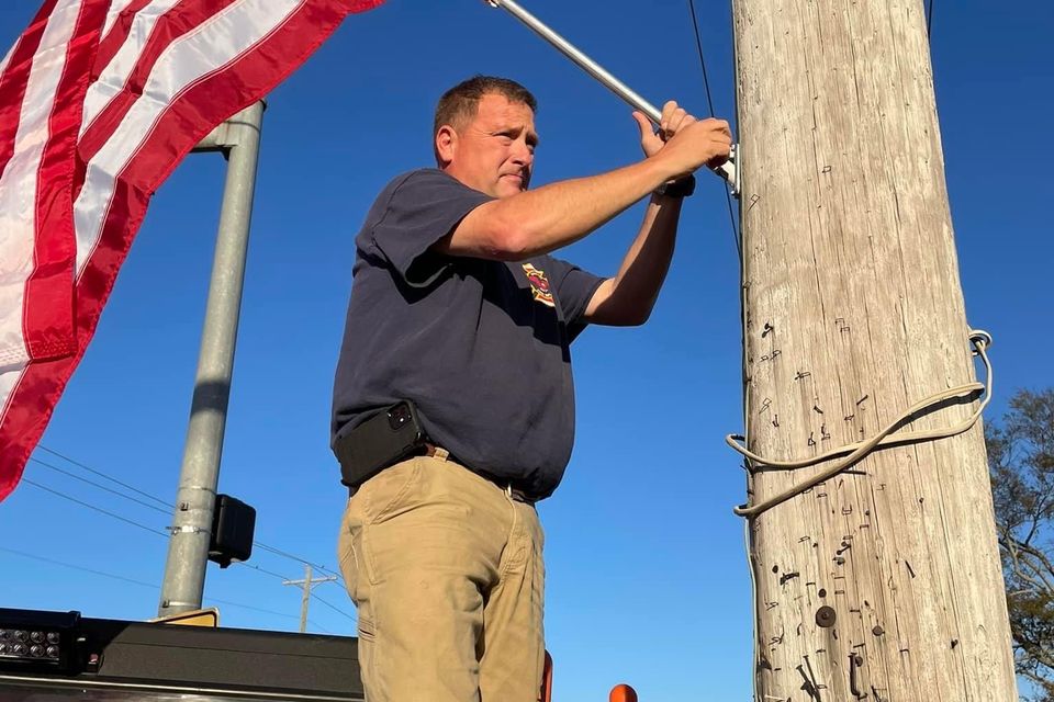 Photo of Vilonia Chamber of Commerce and Vilonia Fire Department Posting Flags On Light Poles