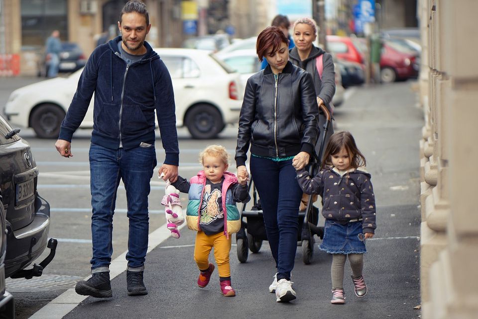 Busy Family Spending Time Together Image of a family walking down the street
