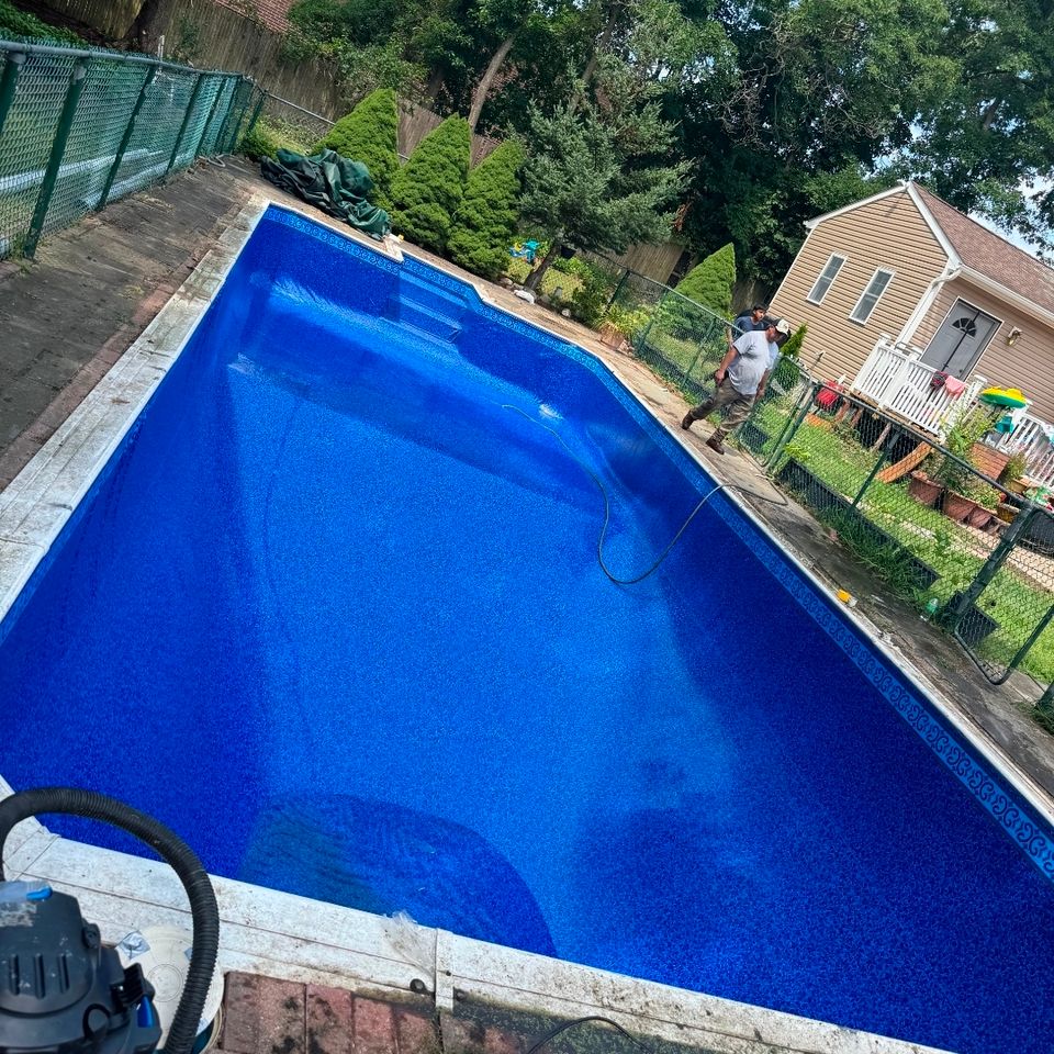 Rectangular inground pool with new patterned liner and tile border after a liner replacement