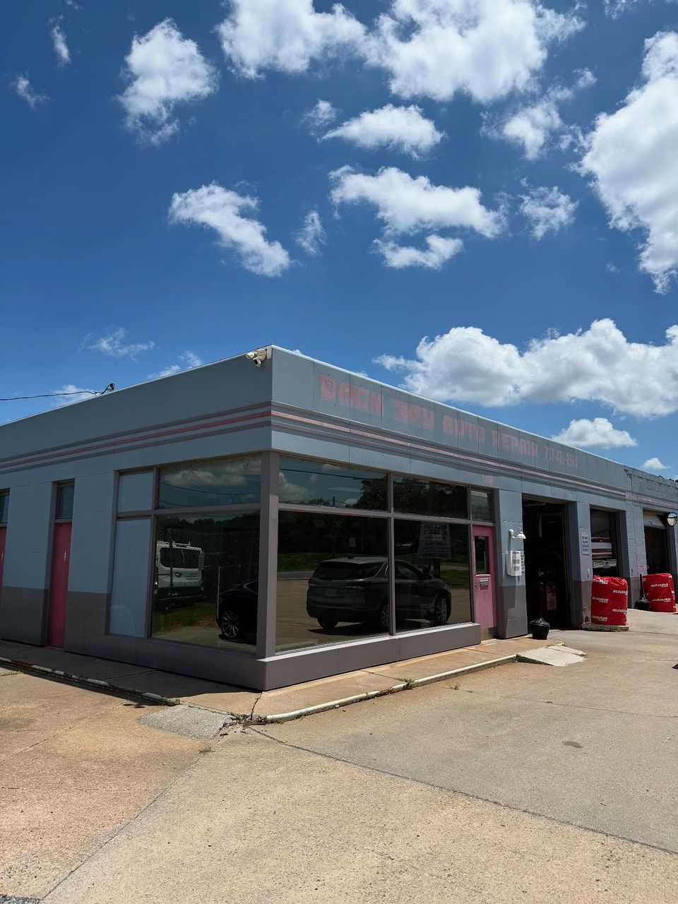 Back Bay Auto Repair shop exterior with large tinted storefront windows