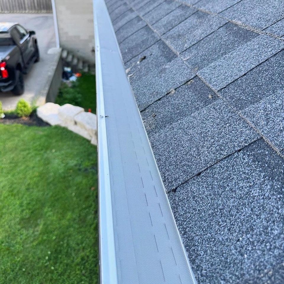 Newly installed gutter guard running along a shingled roofline in Tillsonburg Ontario
