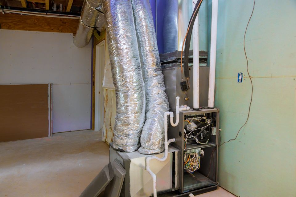 HVAC technician performing furnace replacement in a residential setting in La Vergne, TN.