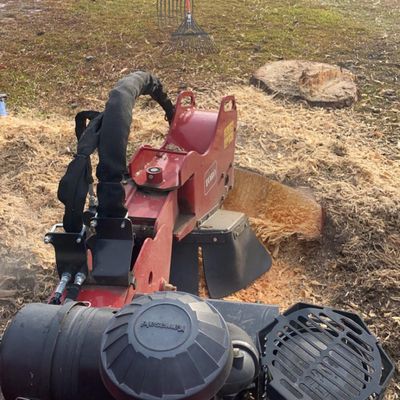 Stump grinding machine clearing a stump area