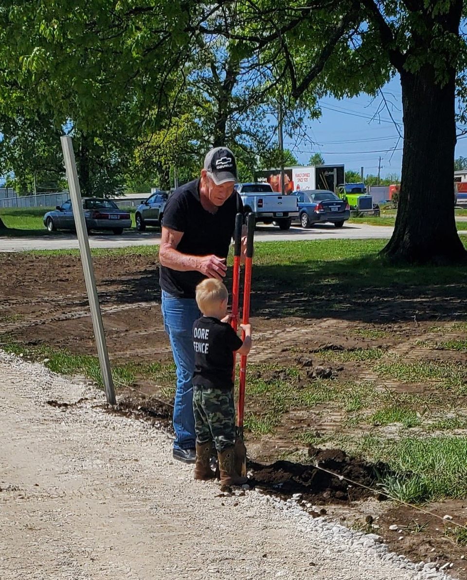Great grandpa dore teaching the littlest dore how to dig a post hole