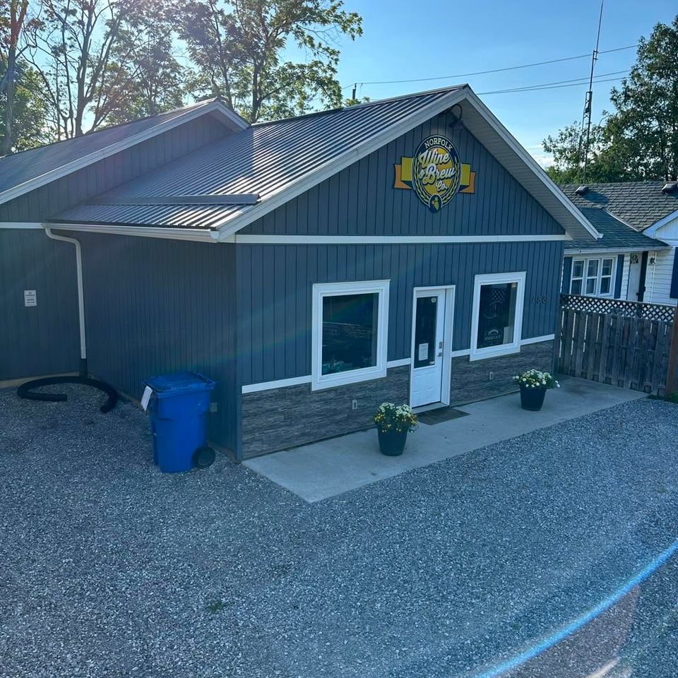 Soft washed blue siding and metal roof on a small commercial building in Tillsonburg Ontario