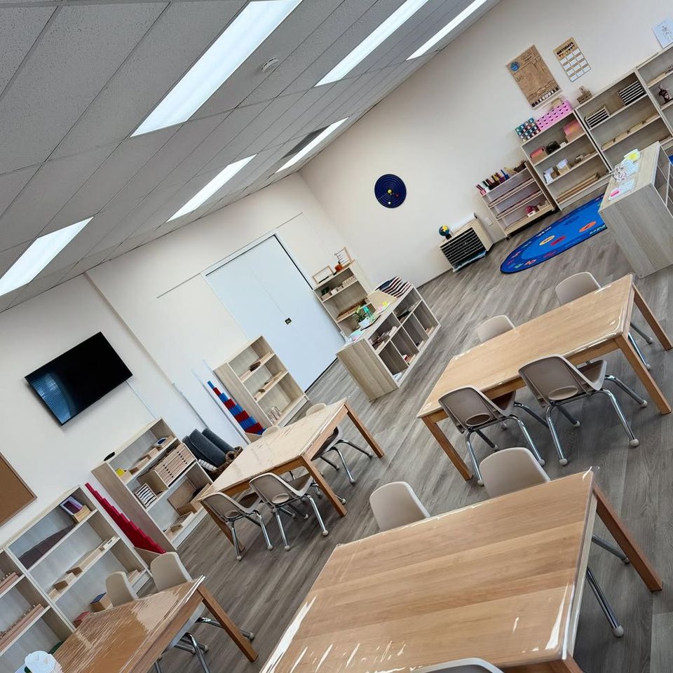 Bright Montessori classroom with wooden tables and learning shelves at a preschool in Palmdale CA