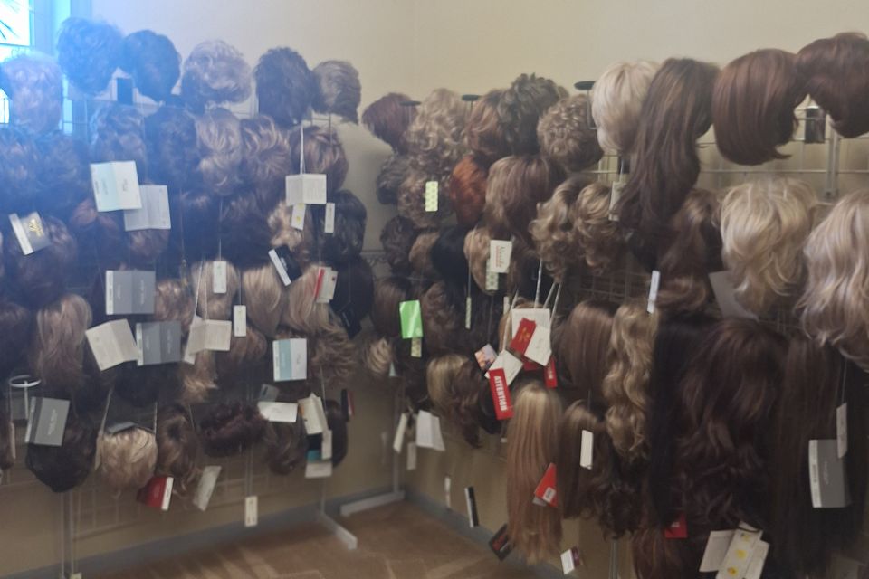 Wide selection of wigs displayed throughout Shears Wigs & Hairpieces Salon, showcasing numerous colors, lengths, and styles available for clients.