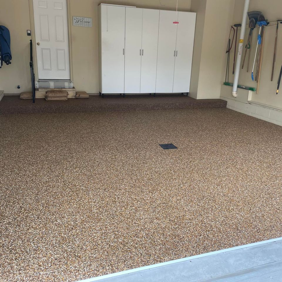 Residential garage with EverStone Epoxy Stone flooring and a seamless decorative stone finish.