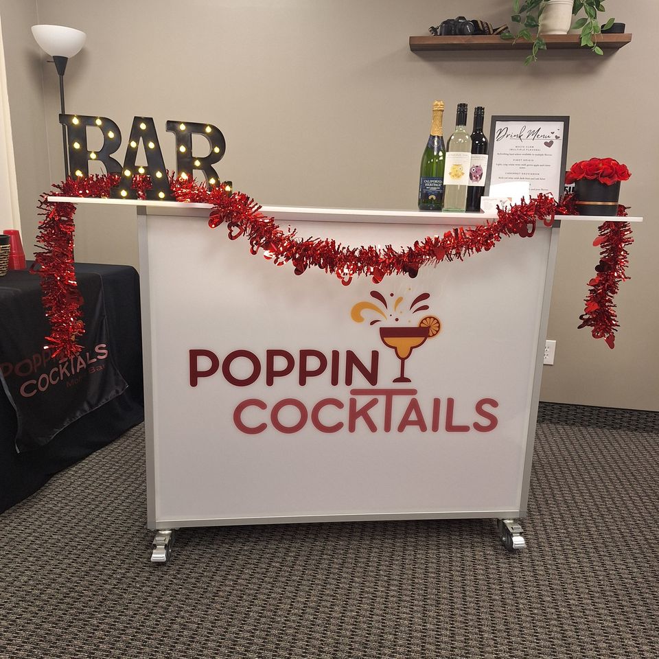 Poppin Cocktails mobile bar with Valentine’s decor and full bar setup at Galentine’s event