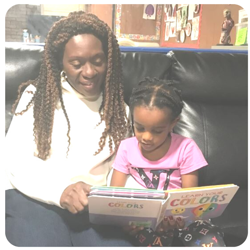 Esther reading with girl on couch in frame
