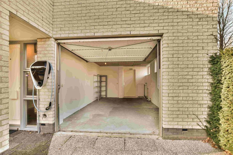 Entrance building with open garage door (1)