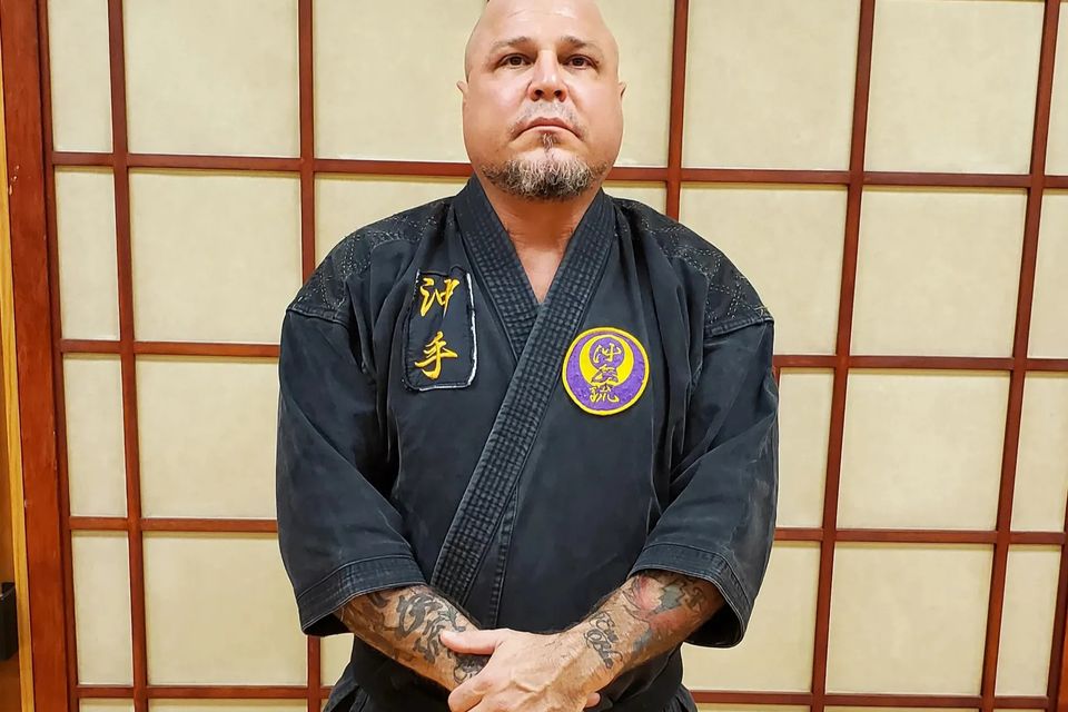 Renshi Patrick Trovato posing for a photo at Takamine Karate Dojo in Miller Place