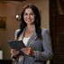 Businesswoman smiling camera while standing restaurant keeping electronic tablet with two hands