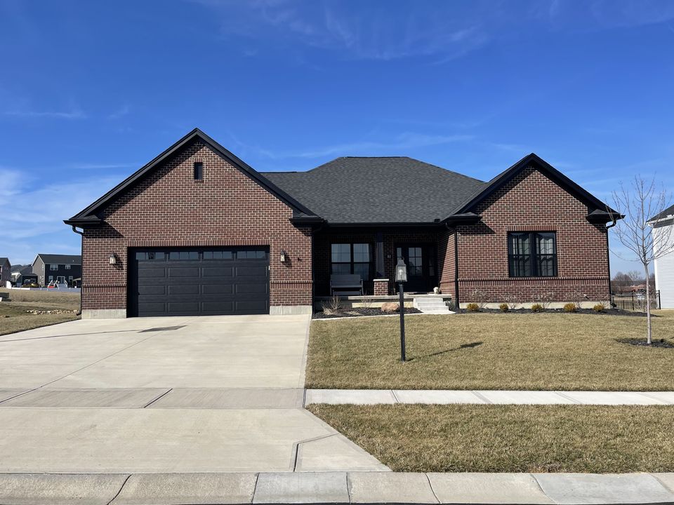 Brick ranch-style home featuring a professionally installed gray architectural asphalt shingle roof by E & D Roofing, Inc.