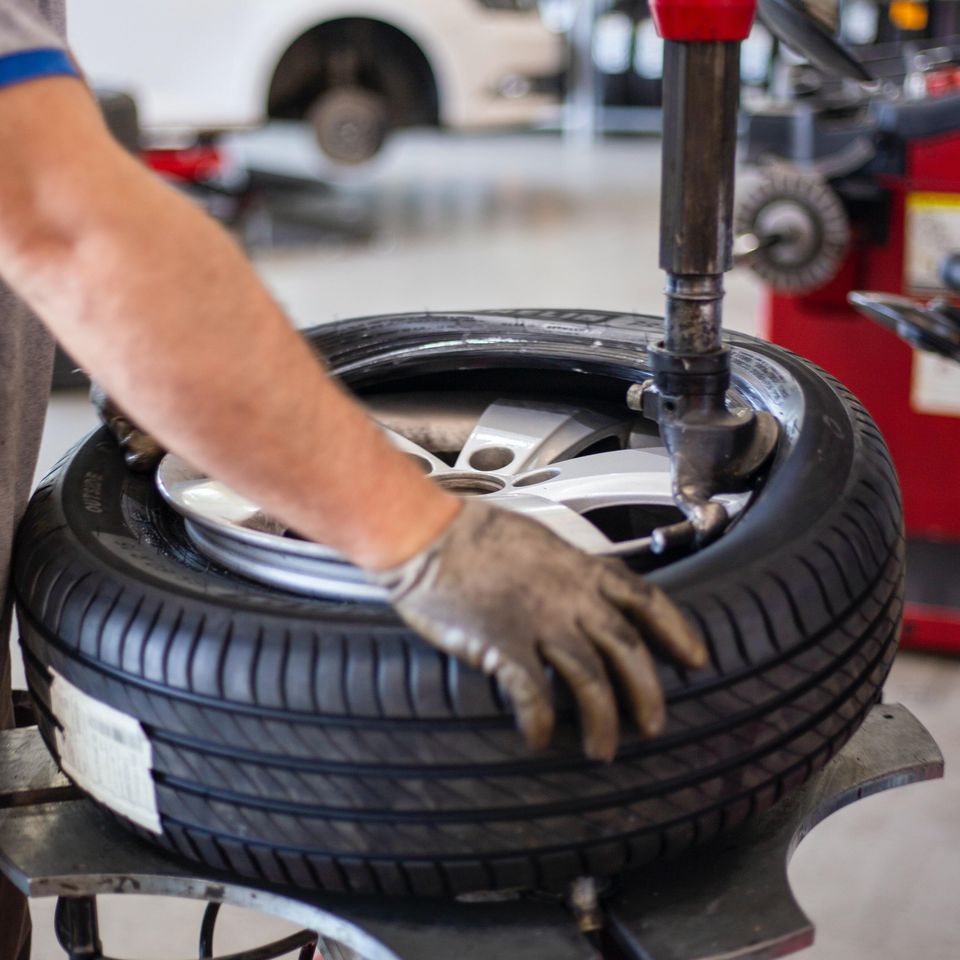 Image of a tire being mounted by a technician