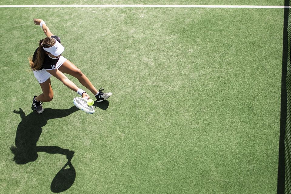 Staying active in Austin’s heat — regular chiropractic care can help prevent and recover from common tennis injuries. Middle-aged woman playing tennis in Austin TX to illustrate sports injury prevention with chiropractic care