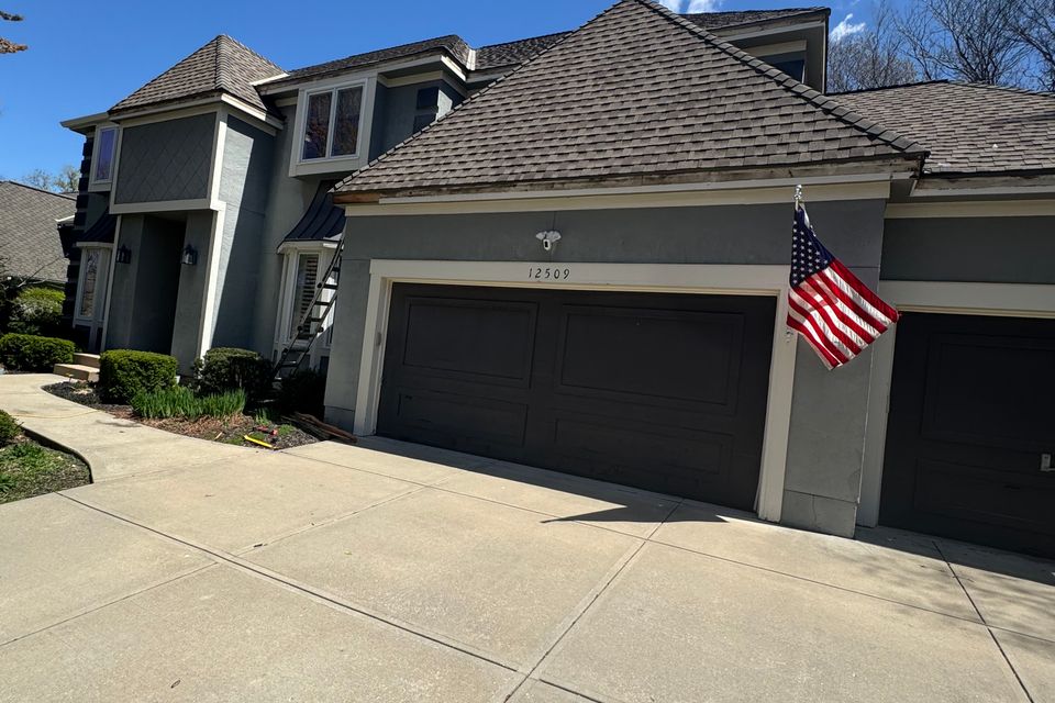 Modern house concrete driveway shingle roof patriot pro exteriors kansas city 309963ea 5899 45e9 93d0 8cc8e4339bde