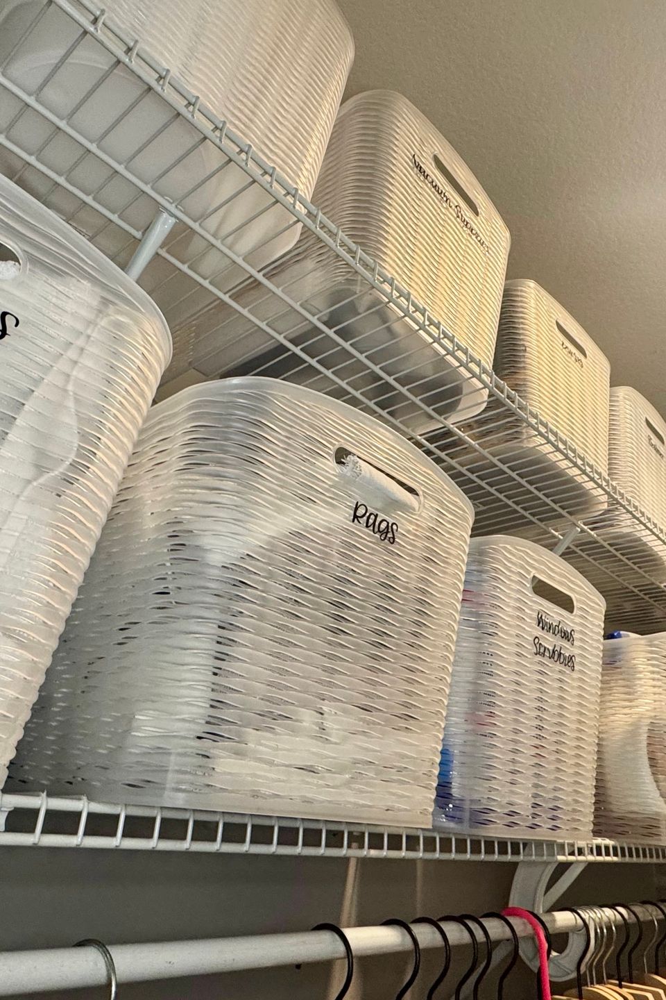 towels in bins and hampers with shoes and hangers in a closet