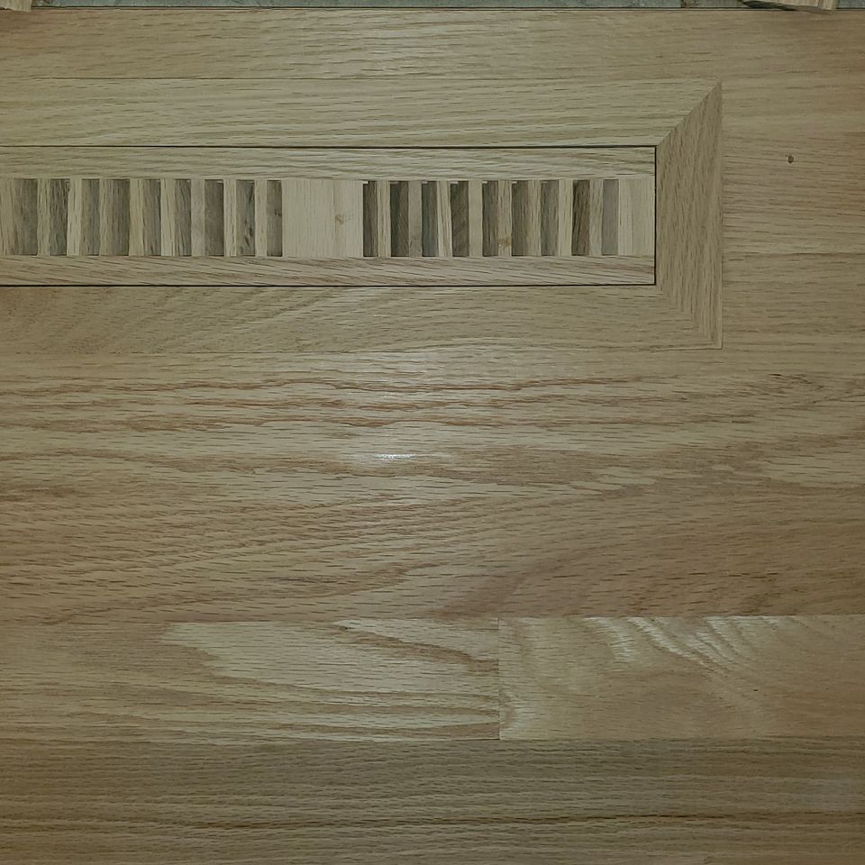 Hardwood flooring, built around a vent cover, done by Siti Floors of Northeast Ohio