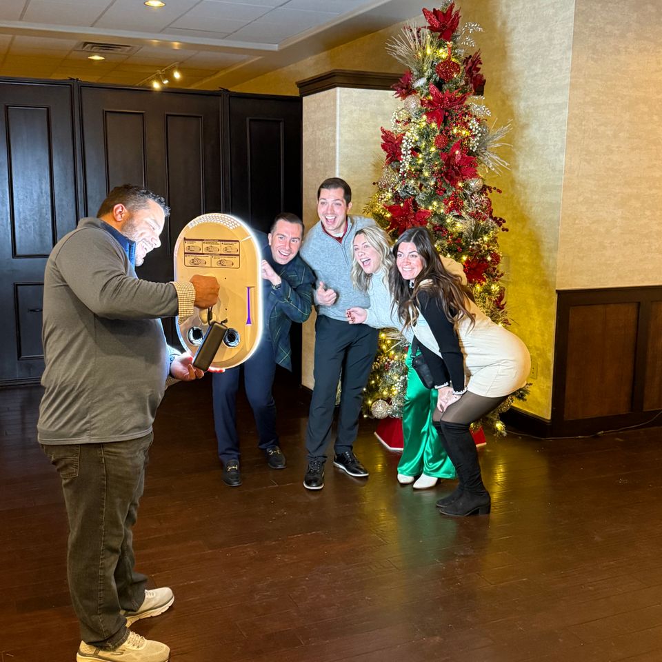 Holiday party guests gathered for a fun photo booth moment.