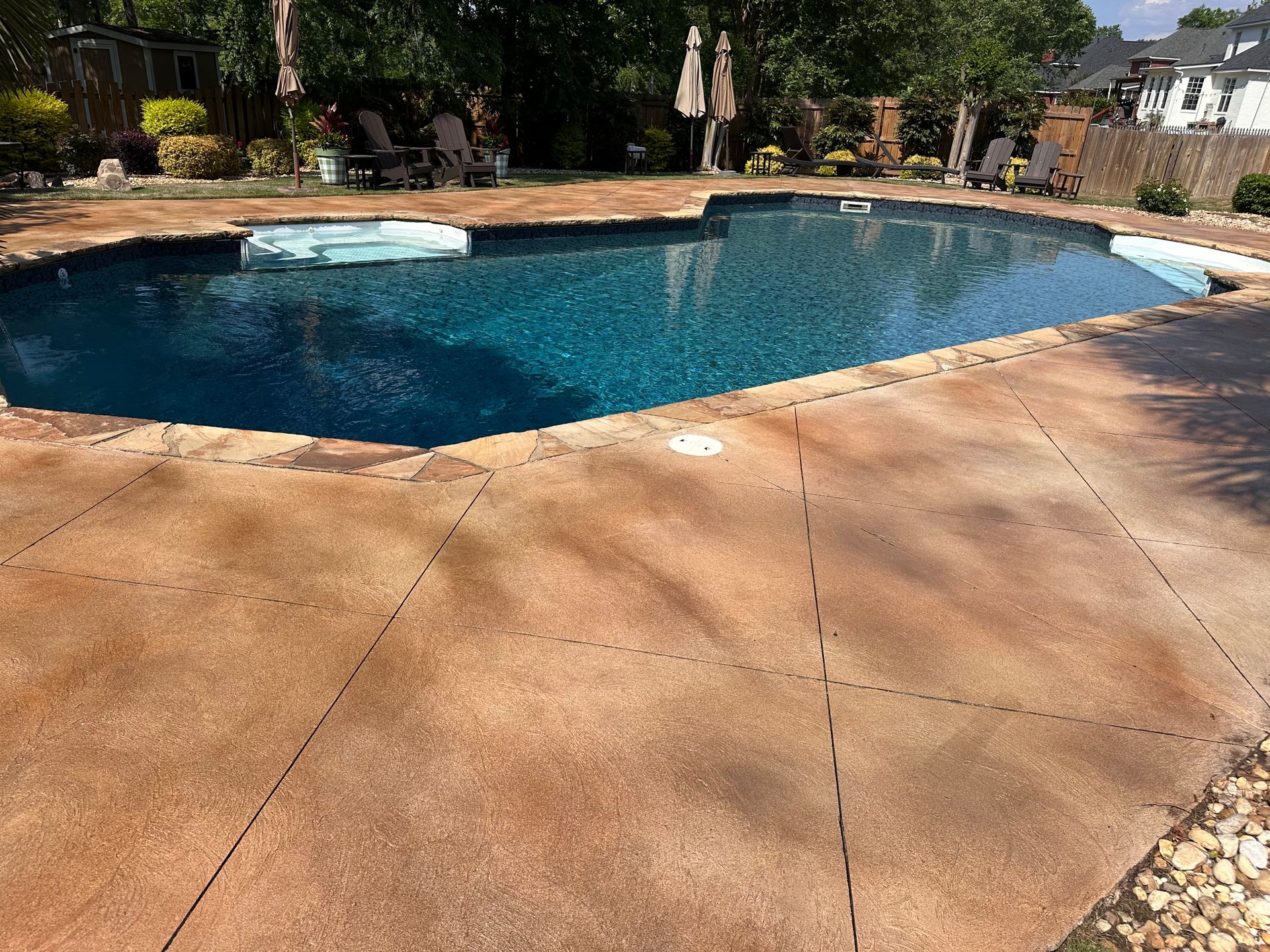 After photo of pool deck surface around swimming pool with decorative concrete finish