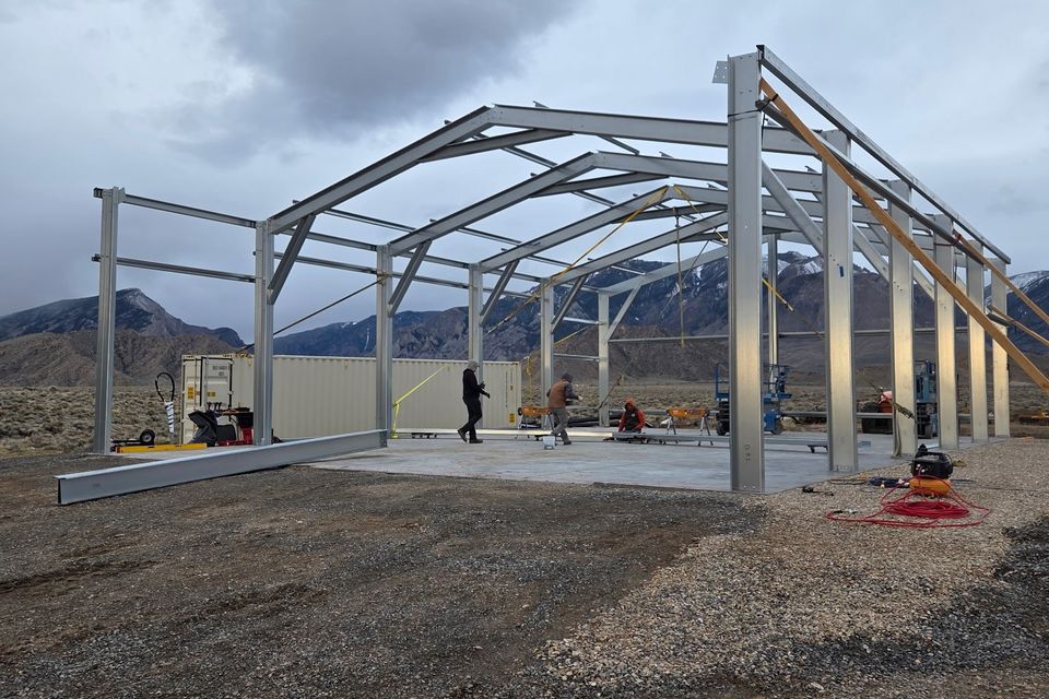 Steel building frame with rigid gable trusses erected during metal building construction in Trout Creek MT