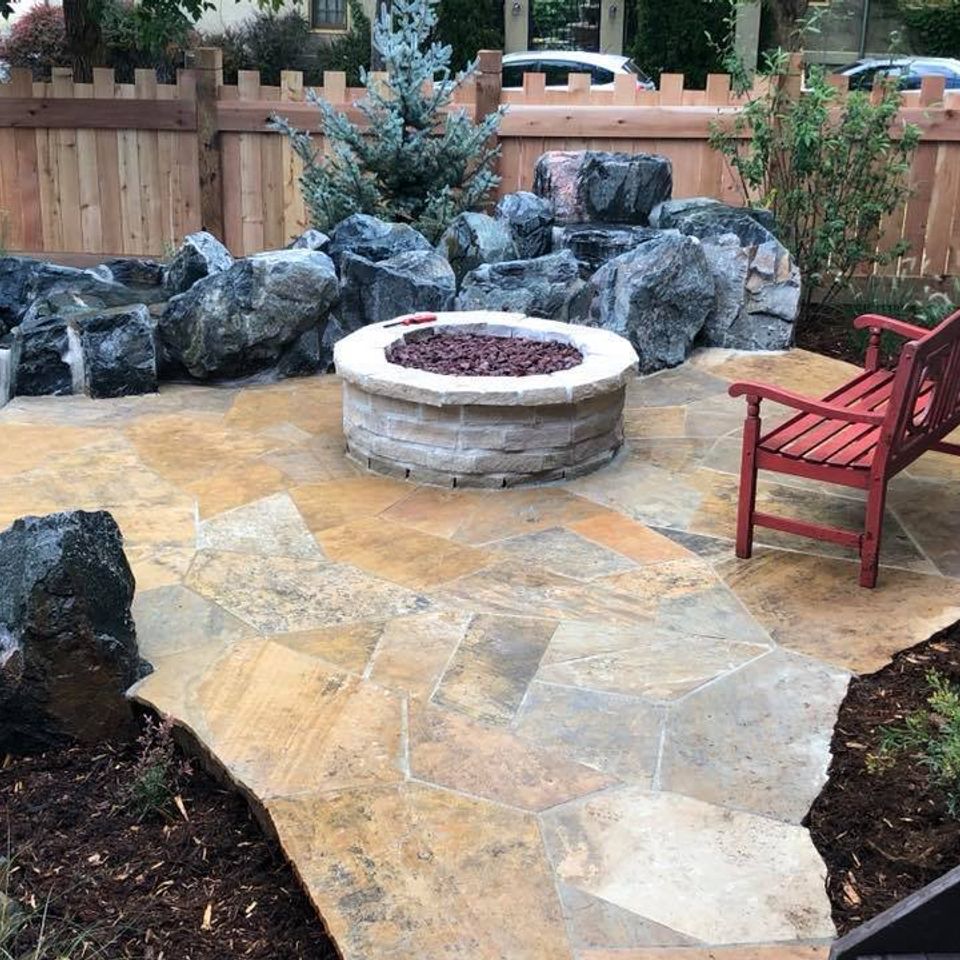 Firepit patio with stone river water feature