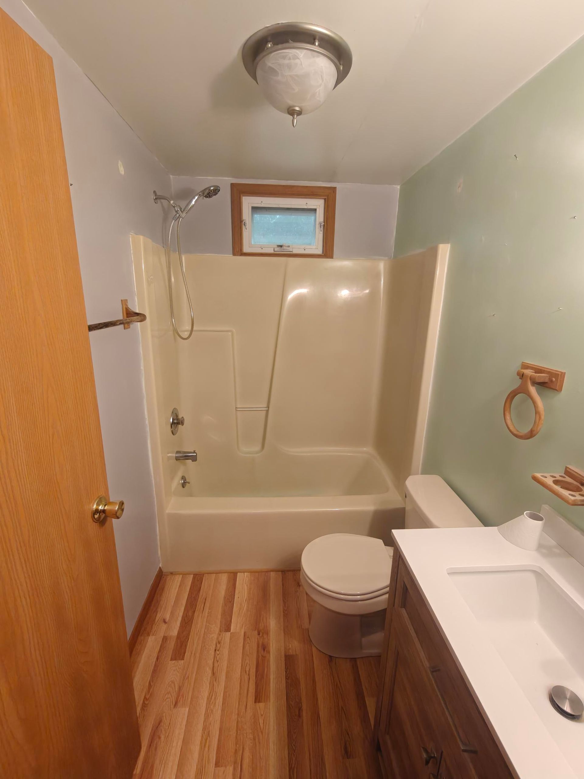 Old beige fiberglass tub and shower before replacement