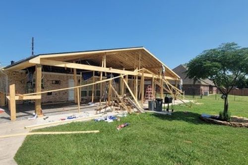New cedar patio frame takes shape behind brick home in The Woodlands, TX